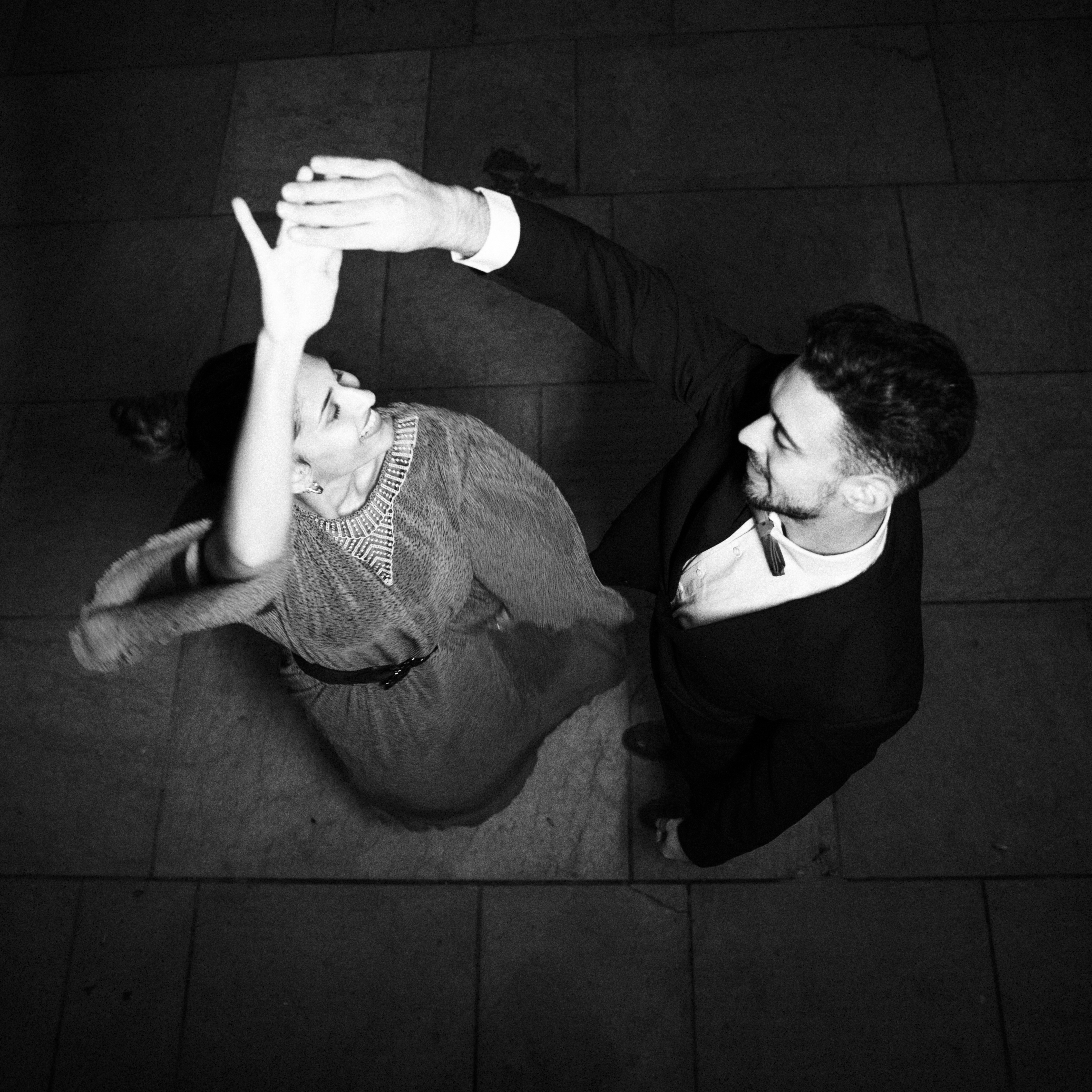 young-guy-holding-hand-dancing-charming-cheerful-lady